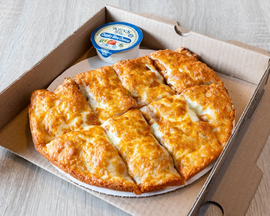 Crow Point's buffalo chicken calzone, baked golden and sliced into strips, fresh out of the oven in its box